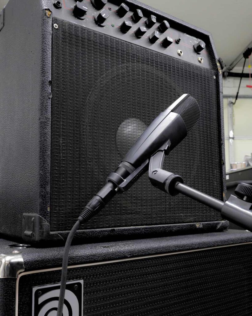 A Sennheiser MD421 with a MicLock clip arm recording an amplifier.